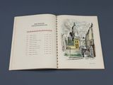 un livre ouvert sur lequel figure le dessin d'un bâtiment