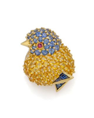 un gros plan d'une broche en forme d'oiseau ornée de pierres bleues et jaunes