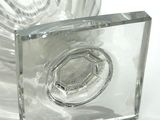 a clear glass vase with a clear base on a white surface