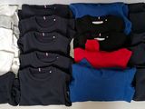 many t - shirts laid out on a white table