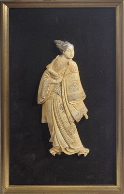 an antique carved ivory figure of a woman holding a basket