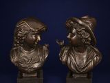 pair of bronze busts of a boy and a girl