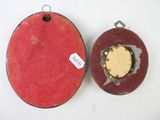 a red box with a gold disc inside of it