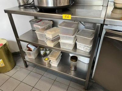 many containers of food on a metal shelf in the kitchen