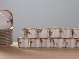 a stack of plates and cups sitting on a table