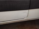 a white truck with a black door and a black door handle