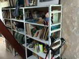 a bookshelf in the corner of a room with a lot of books