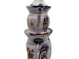 a white vase with a blue and gold design on it
