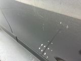the door of a car with a lot of scratches on it