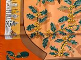 orange and green scarf with a picture of a coat of arms and a coat of arms