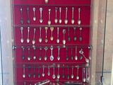 many spoons and spoon spoons on display in a glass case