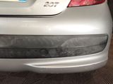 rear end of a silver car with a number plate on it ' s bumper