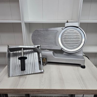 an image of a meat slicer sitting on a table