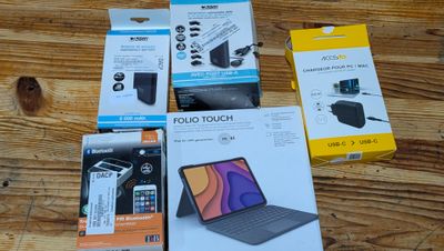 several boxes of various electronic devices on a wooden surface