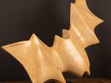 a sculpture of a bat on a wooden table