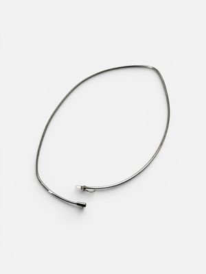silver plated bang bracelet with a curved bar on a white background