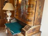 a wooden cabinet with a green cushion on it