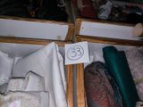 a wooden box filled with different types of clothing