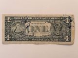 an old one dollar bill on a white surface