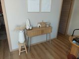 a wooden table with a vase on it in a room