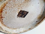 a close up of a plate with a cracky surface