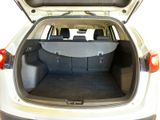 the back of a white car with its trunk open and the back seats down