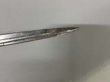 a fork sticking out of the side of a white wall