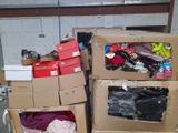 several boxes of clothing are stacked on top of each other in a warehouse
