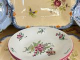 three plates and a bowl sitting on a table