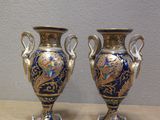 two vases that are sitting on a table
