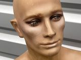 a mannequin of a man with no shirt on