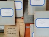 a lot of old books that are stacked on top of each other
