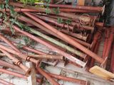 a pile of rusted pipes and pipes on the ground