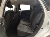 the back seats of a white car with a black seat belt