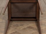 an image of a wooden chair with a leather seat on a parquet floor