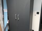 a black cabinet in the corner of a room