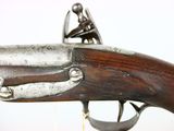 an old gun with a wooden handle on a white background