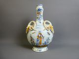 un vase bleu et blanc orné d'une image de Jésus