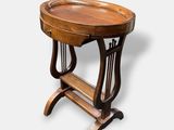 an old wooden table with a wooden tray on top of it