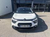 the front of a white citrole parked in front of a building