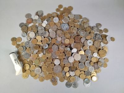 a pile of coins sitting on a table with a roll of paper