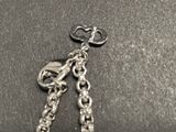 a keychain with a chain attached to it on a table