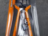 an orange and black pliers are in a package on a table