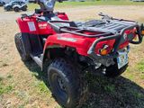 an image of a red four - wheeler atv parked in a field