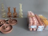 many different types of vases and candles on the table