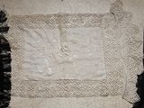 a white piece of cloth on a table with a pair of scissors