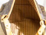 a brown and tan bag sitting on top of a wooden table