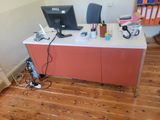 a desk with a computer and a monitor on top of it