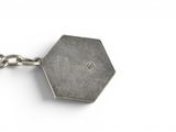 silver hexagon keychai with chain on a white background