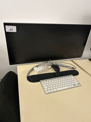 a desk with a keyboard and a monitor on it